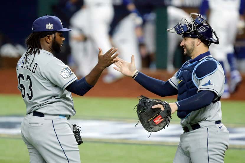 Tampa Bay Rays catcher Mike Zunino (10) congratulates relief pitcher Diego Castillo (63) on...
