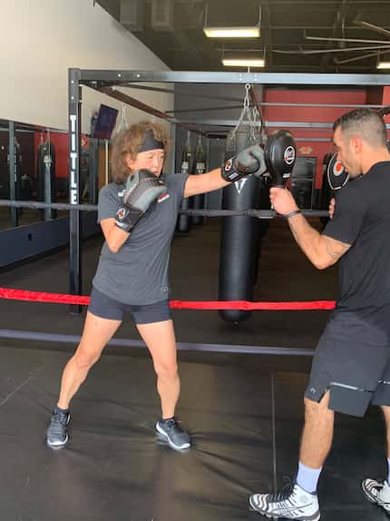 Anne Chow, CEO of AT&T Business, works out with trainer Christafer Duran at Title Boxing...