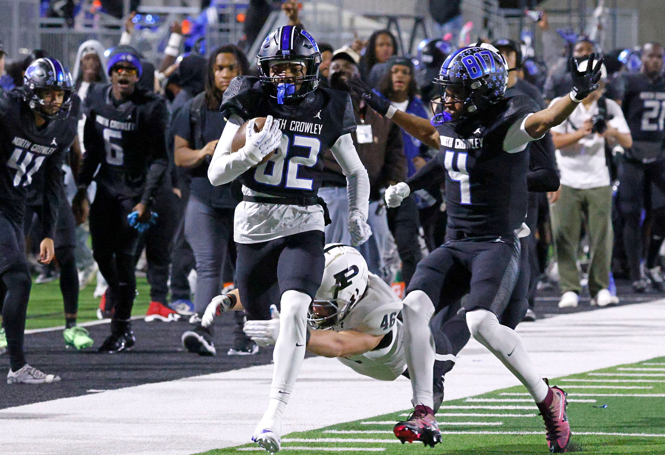 North Crowley's Malachi Releford (82) carries the ball as Permian's Elijah Marquez (48)...