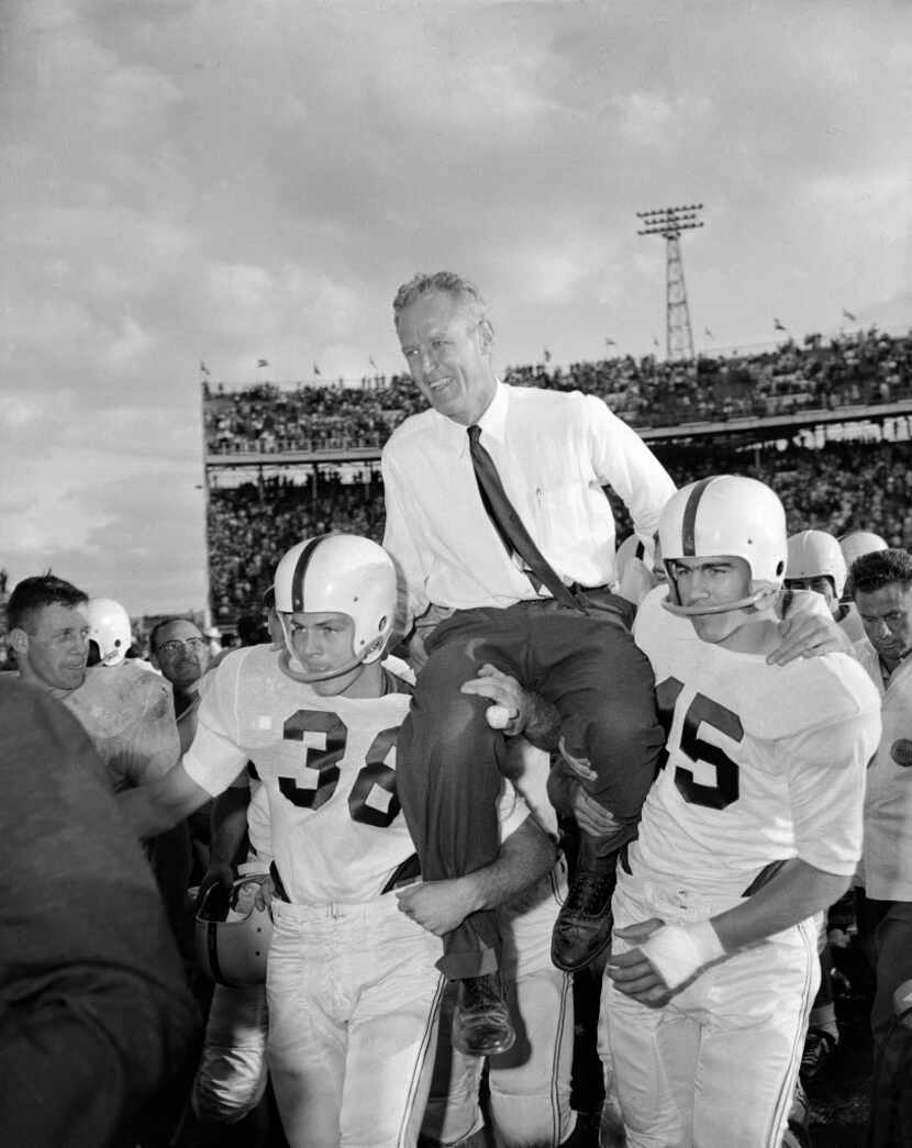 Oklahoma coach Bud Wilkinson is hoisted to the shoulders of his quarterback Rodger Taylor,...