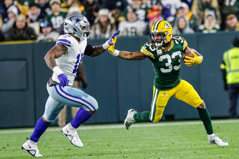 Green Bay Packers running back Aaron Jones (33) runs the ball during an NFL game against the...