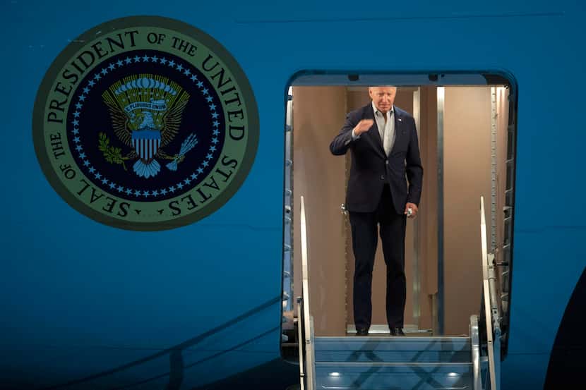 President Joe Biden salutes as he boards Air Force One for a trip to Israel and Saudi...