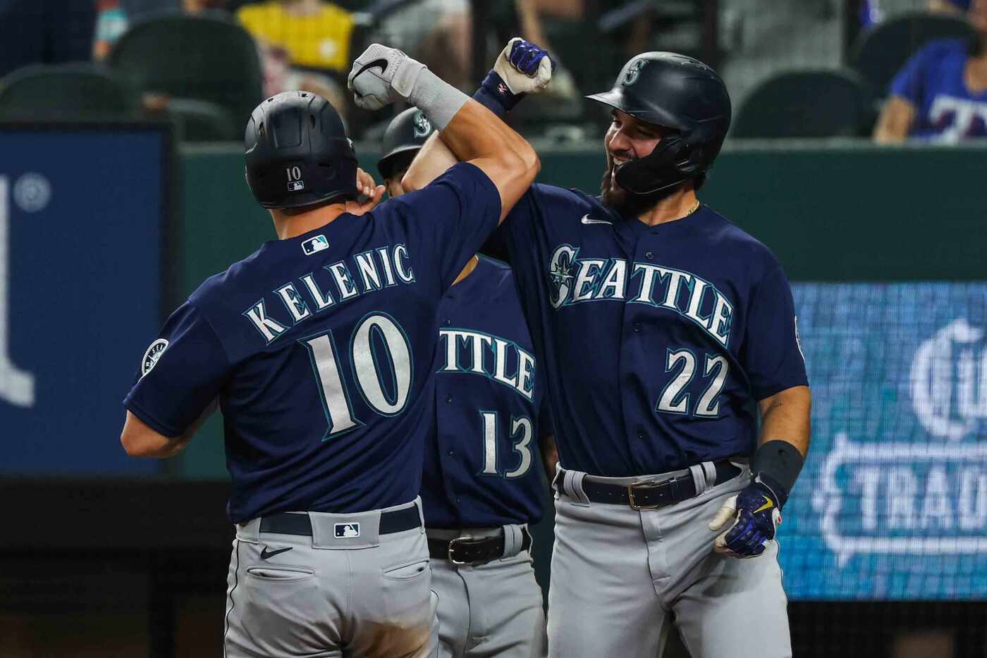 Seattle Mariners Dylan Moore (10) celebrates his homerun with Tom Murphy (22) in the third...