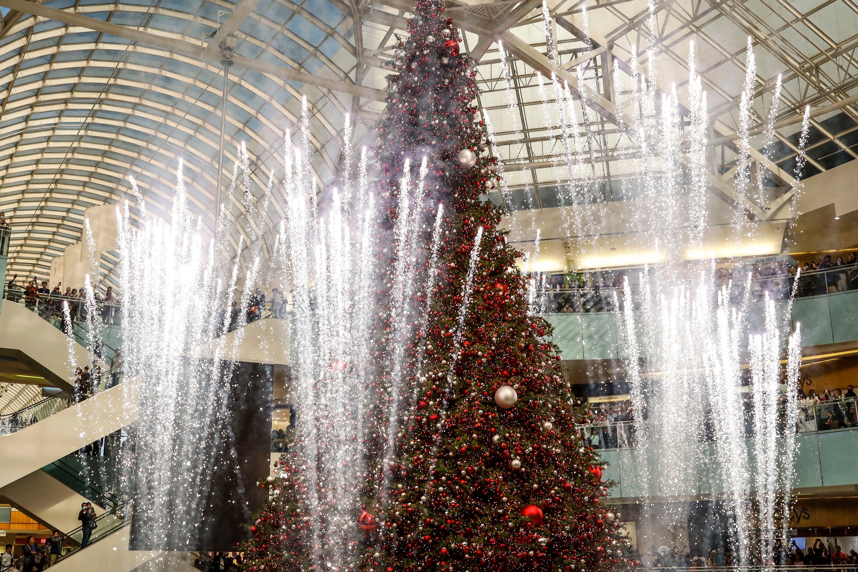 Towering in the middle of a skating rink at Galleria Dallas stands what is described as...