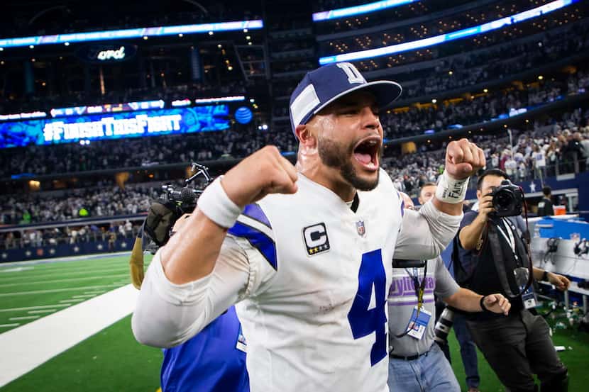 Dallas Cowboys quarterback Dak Prescott celebrates as he leaves the field following a...
