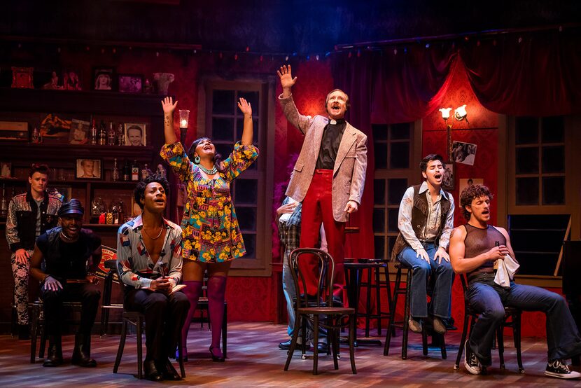 Steven Pounders as the priest, Richard, stands on a chair as the cast of Uptown Players'...