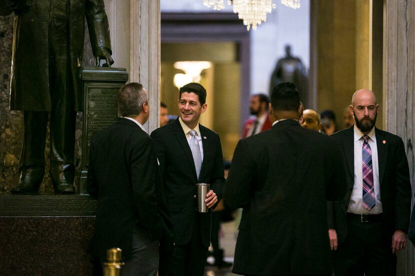 House Speaker Paul Ryan (R-Wis.) heads back to his offices before a final vote on tax...