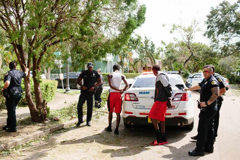 Police arrest looting suspects in the Buena Vista neighborhood of Miami on Sept. 11. About...