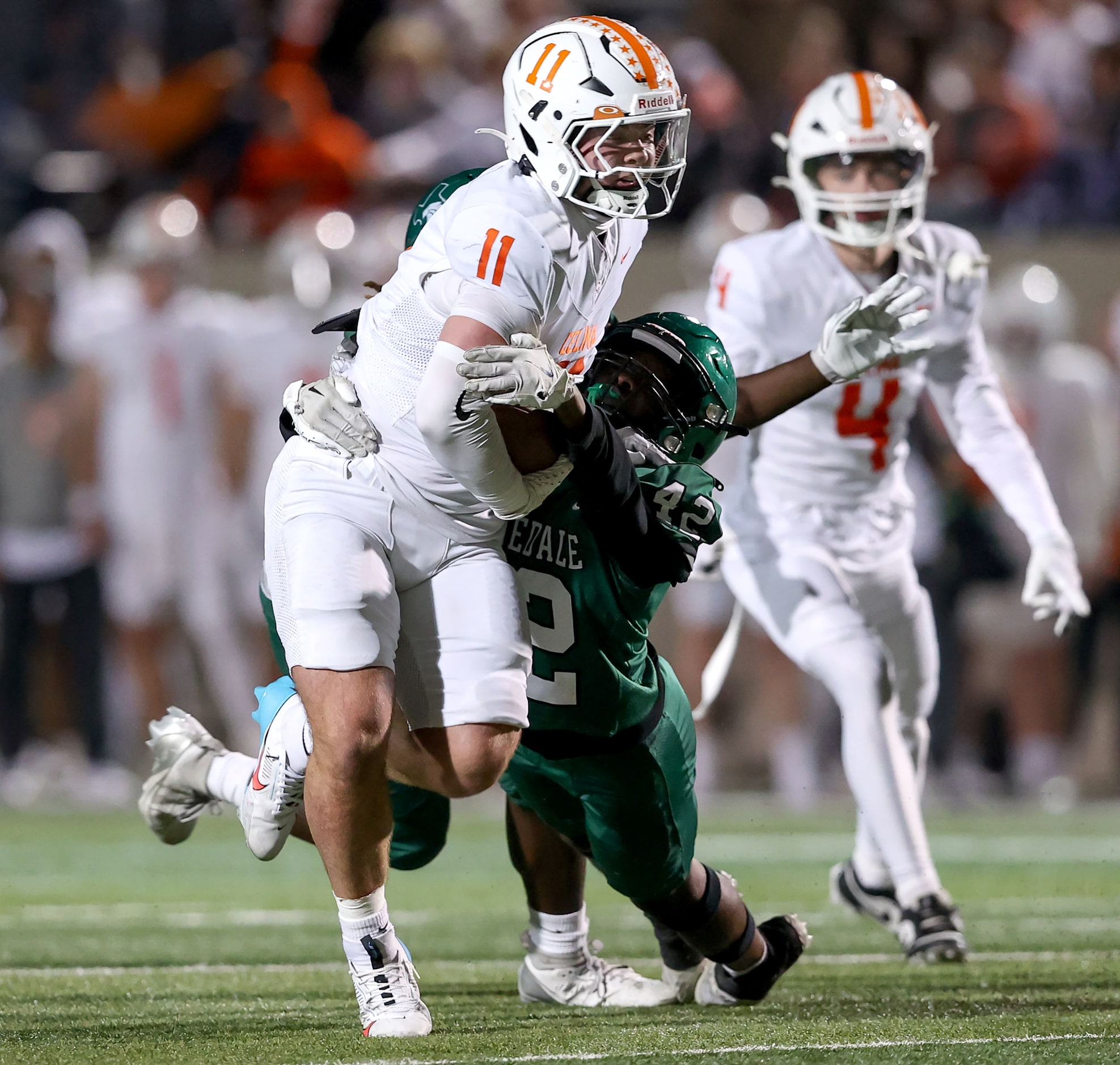 Celina's Luke Biagini (11) is pulled down by Kennedale linebacker Kevonte Johnson (42) after...