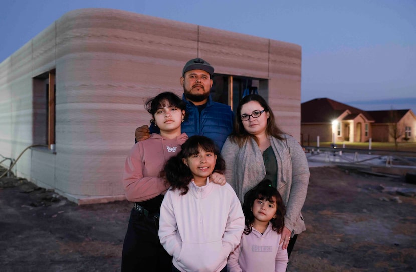 Hugo Briones, center, poses for a portrait with his wife Erica and children Emily, 13, left,...