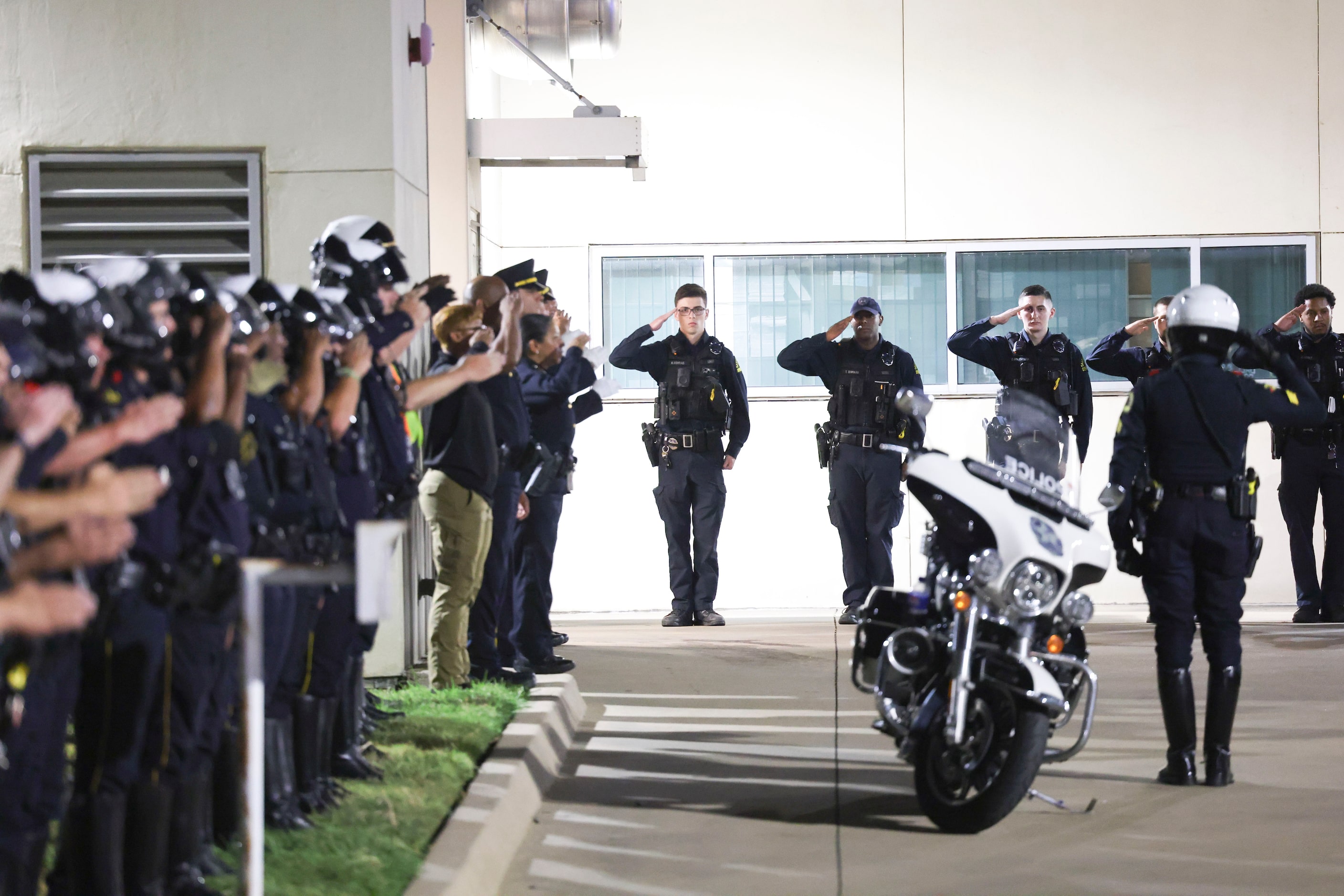 Dallas Police Department officers lead a guard of honor outside of Dallas County Medical...