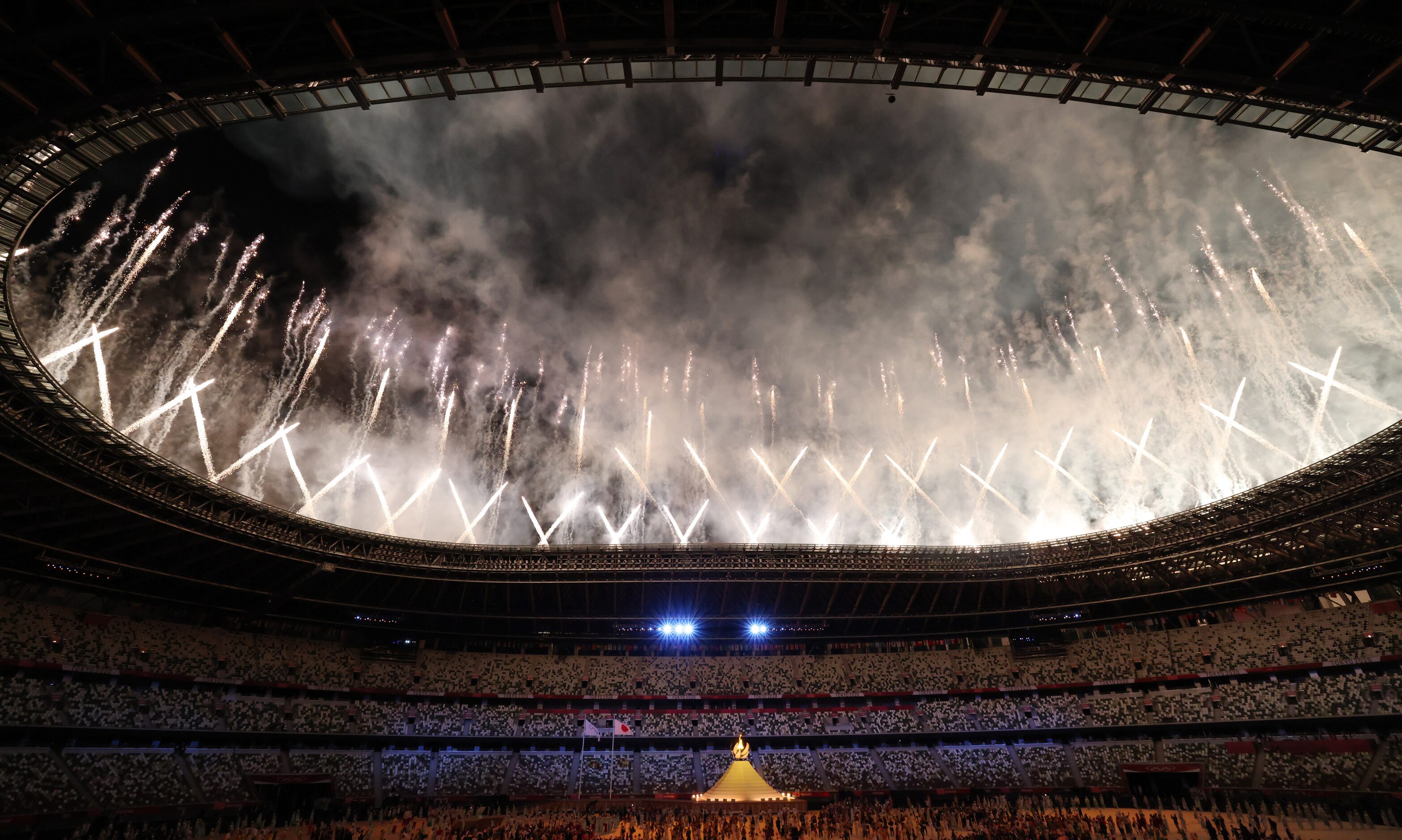 Fireworks go off after the Olympic cauldron was lit during the opening ceremony for the...