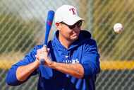 Texas Rangers executive vice president & general manager Chris Young hits grounders to his...