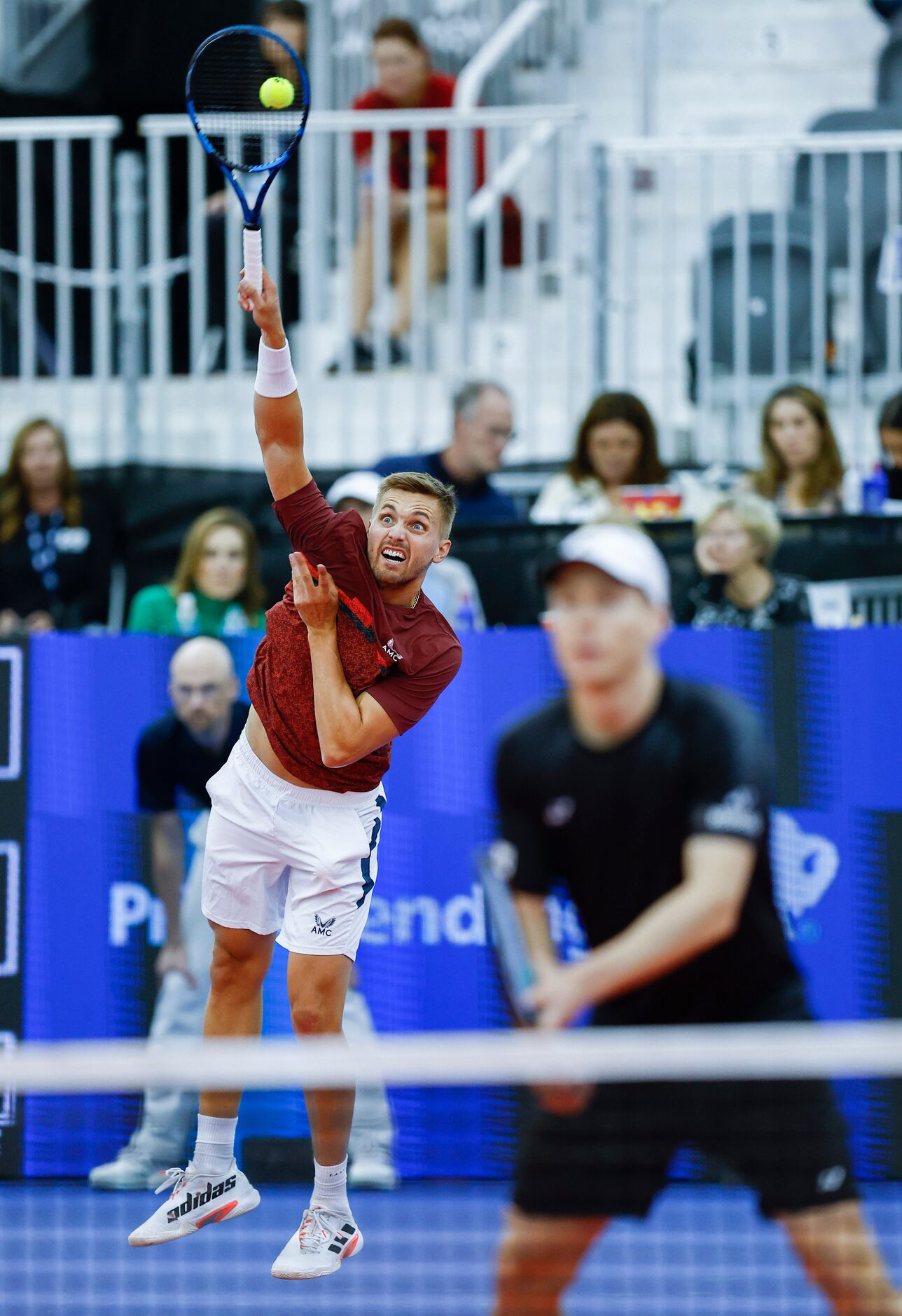 Lloyd Glasspool serves the ball as his teammate Harri Heliovaara stands ready during the...