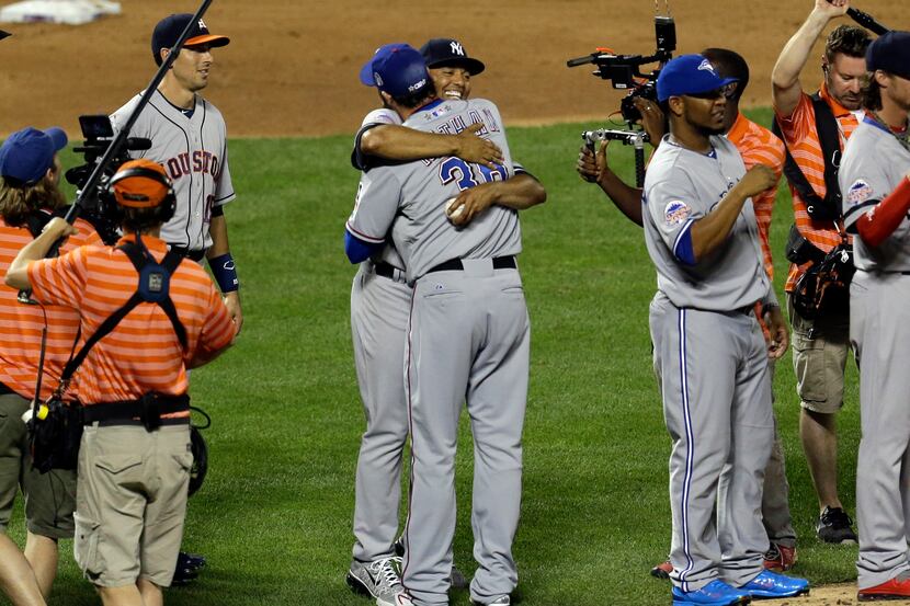American League reliever Mariano Rivera, of the New York Yankees, gets a hug from Joe Nathan...