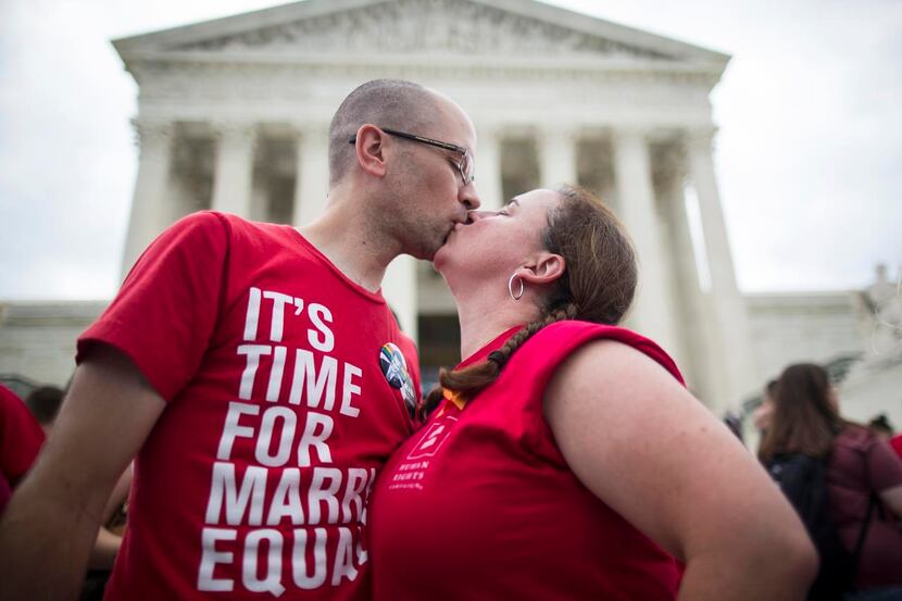 Casey Whiting of the Human Rights Campaign kissed her husband, Nate Whiting, outside the...