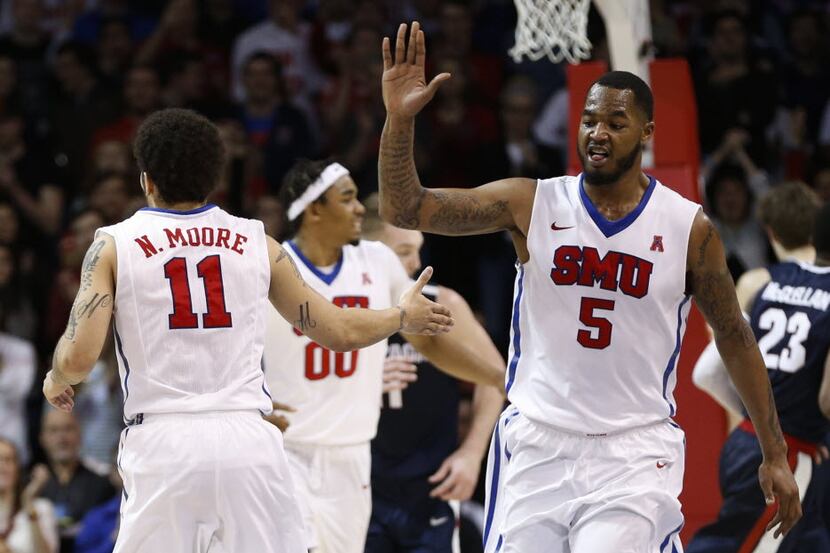SMU guard Nic Moore (11) is congratulated by forward Markus Kennedy (5) on his 3-pointer...