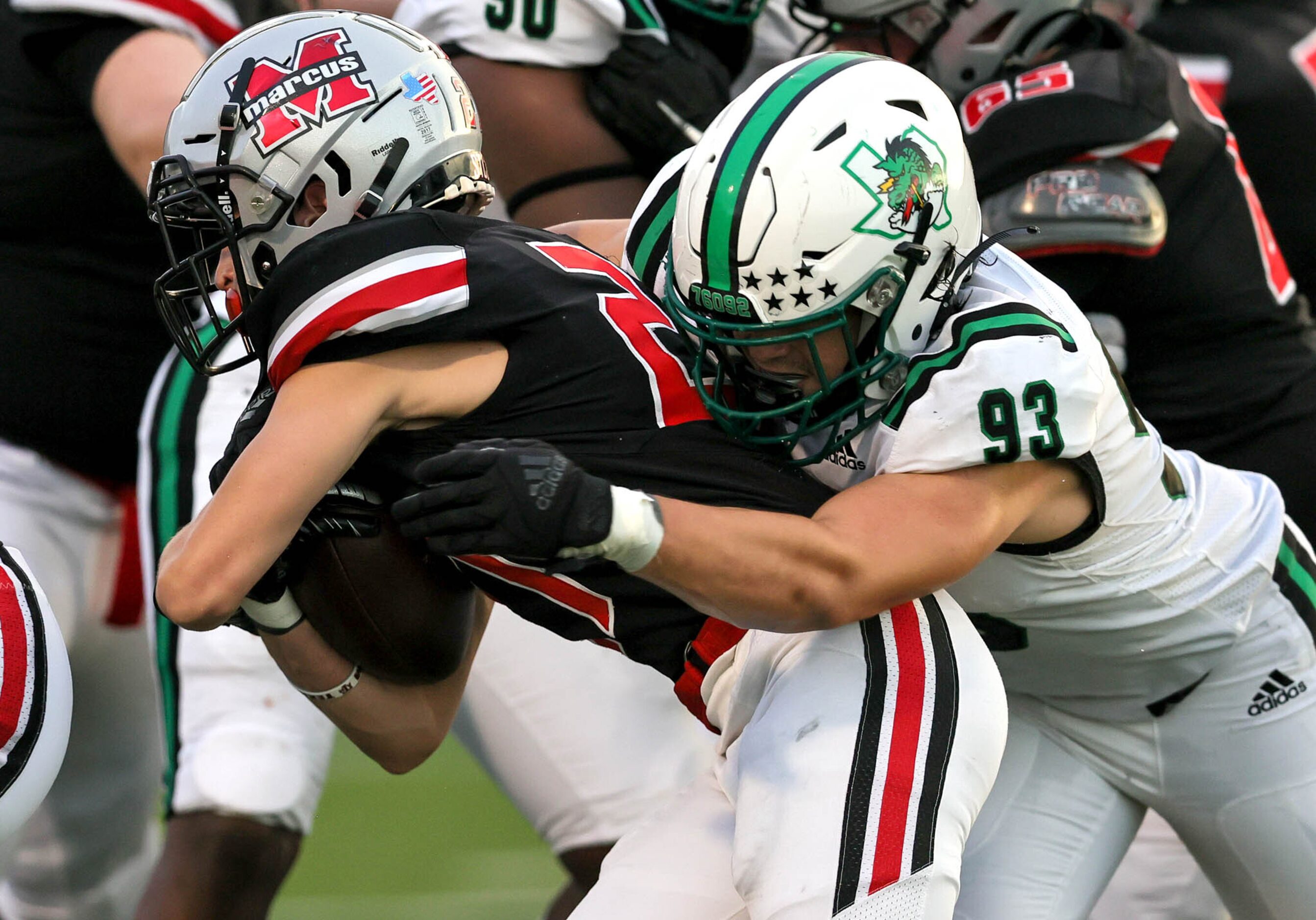 Southlake Carroll defensive lineman Zach Scarborough (93) stuffs Flower Mound Marcus running...