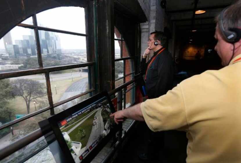 
Visitors peer out a window overlooking Dealey Plaza at the Sixth Floor Museum.
