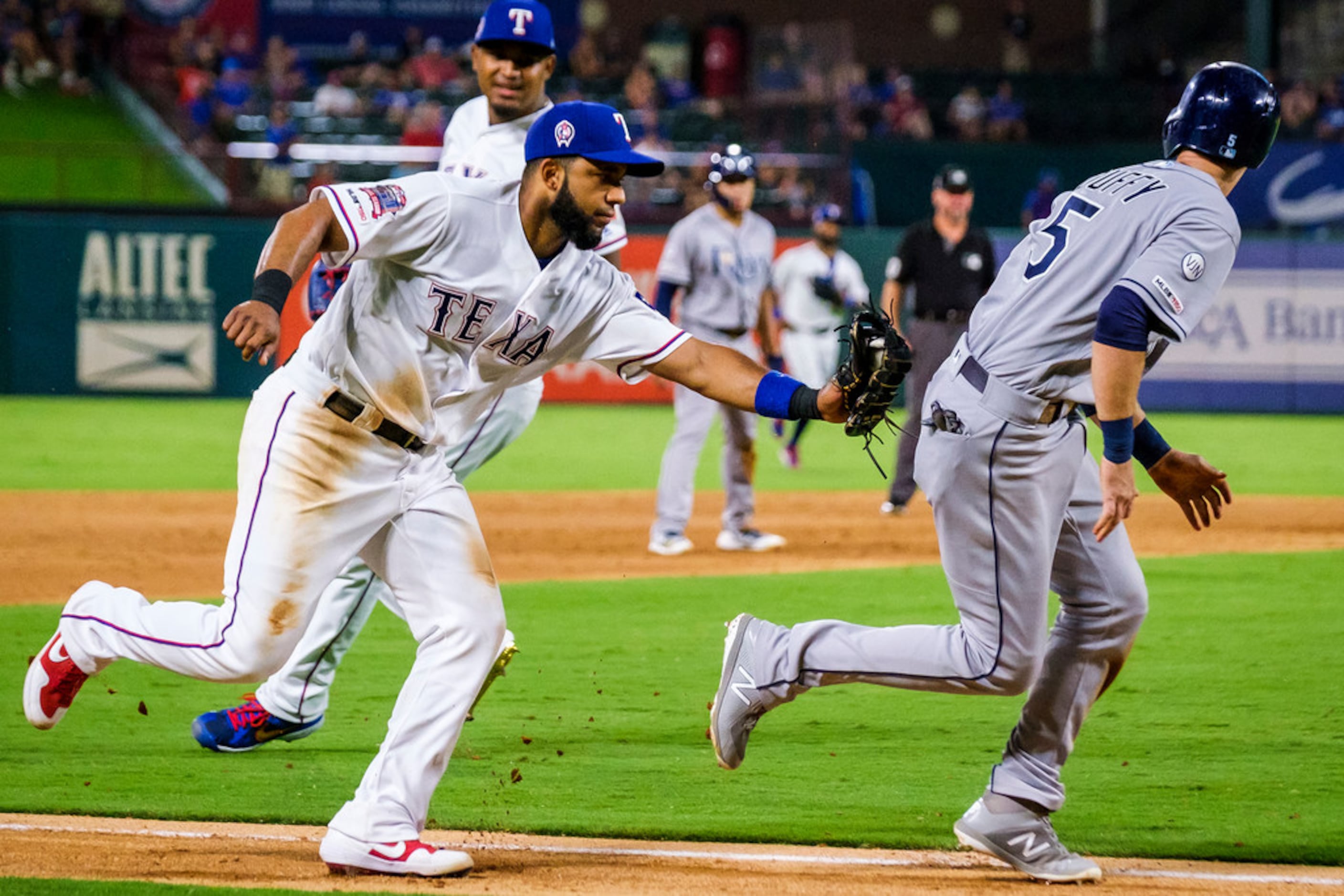 Texas Rangers shortstop Elvis Andrus (1) applies the tag as Tampa Bay Rays third baseman...
