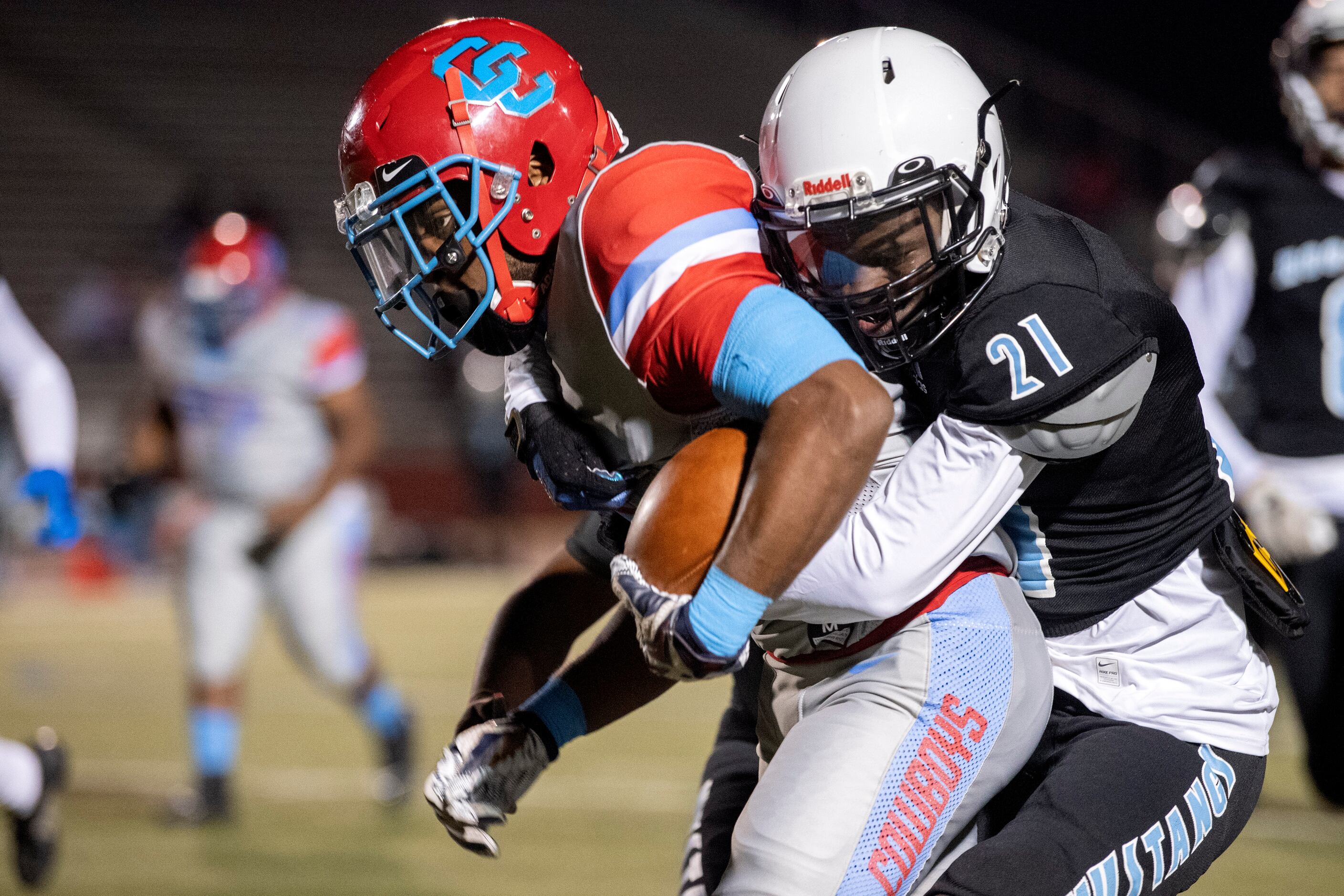 Carter junior running back Javon Jackson (4) is wrapped up by Roosevelt junior defensive...