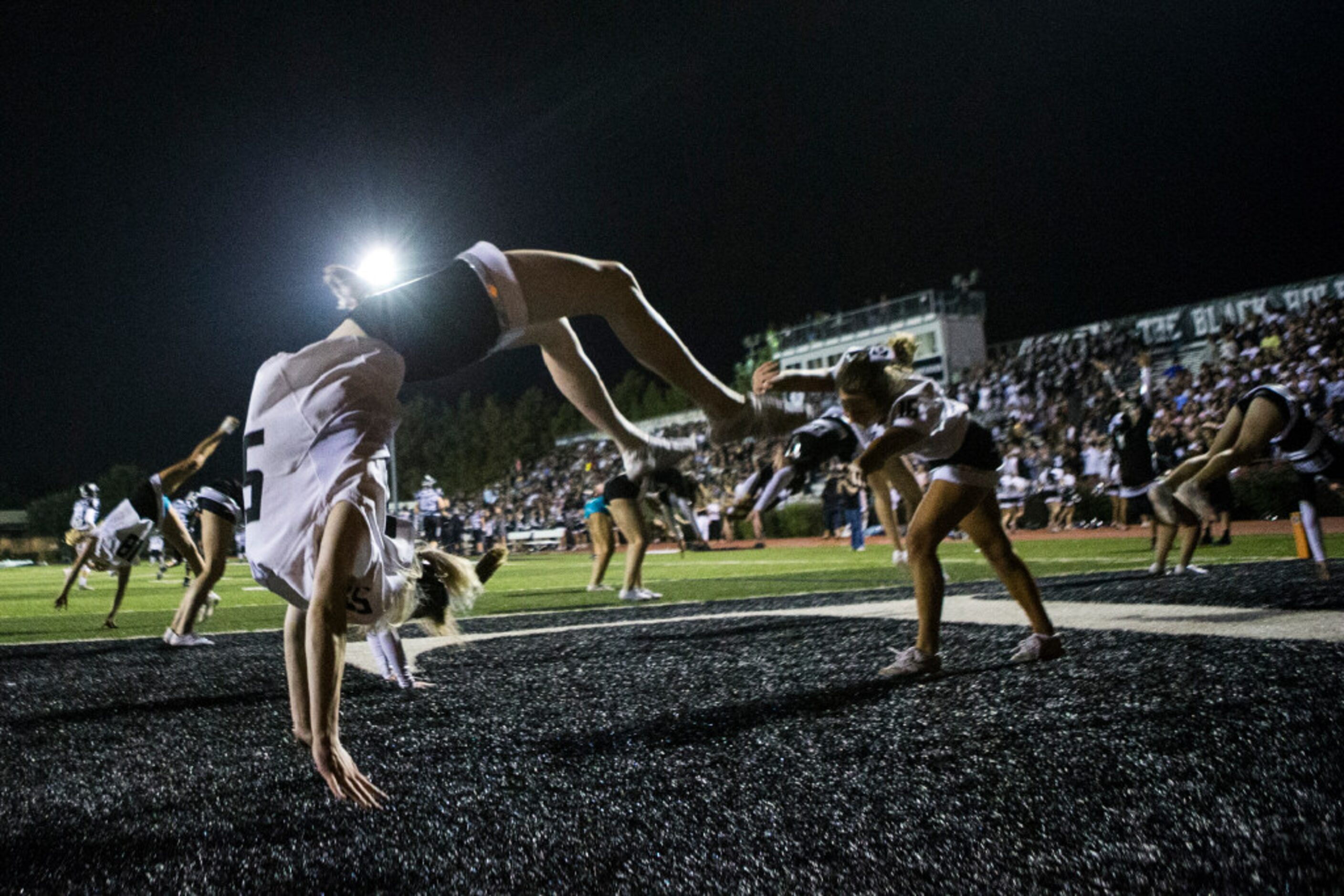 Bishop Lynch cheerleaders do backflips after a touchdown during Bishop Lynch's matchup...