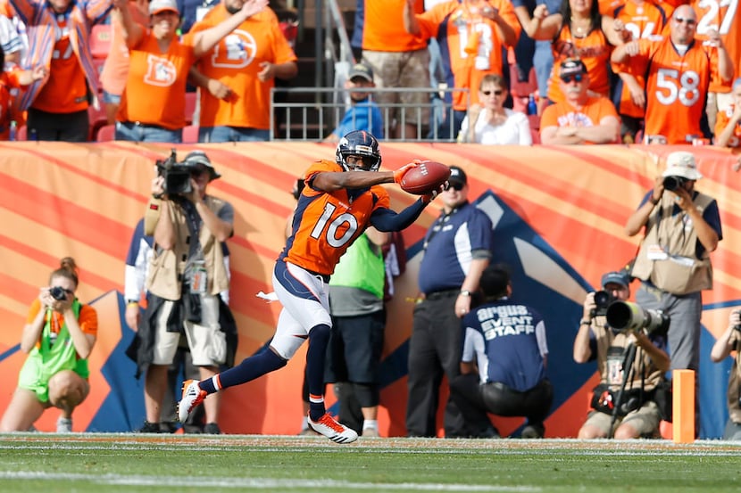 Denver Broncos wide receiver Emmanuel Sanders (10) scores a touchdown in  a game against the...