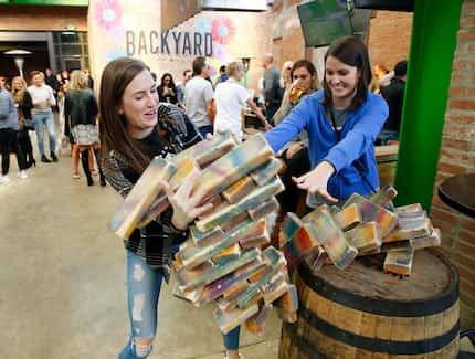 Holly Zeller (left) and Lauren Nutini try to rescue a giant Jenga fall at The Backyard in...