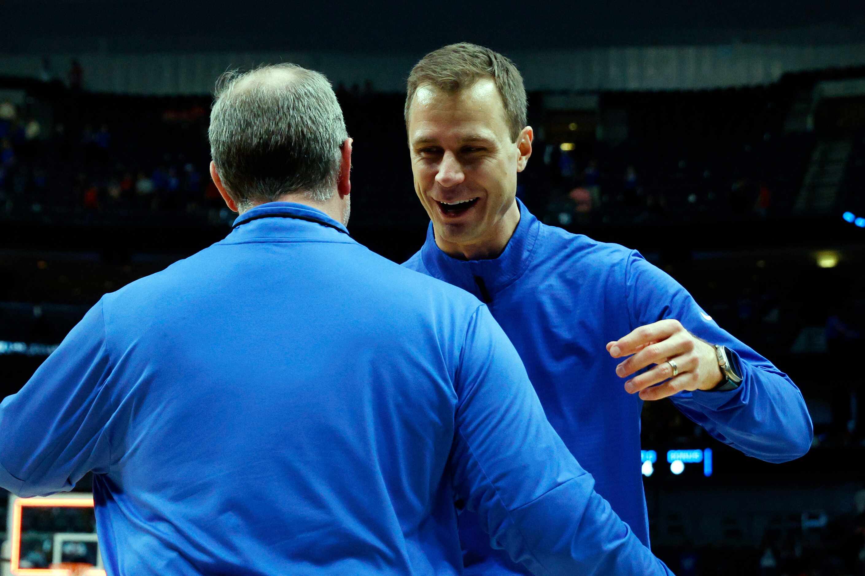 Duke head coach Jon Scheyer celebrates with a staff member after an NCAA Men’s Sweet 16...