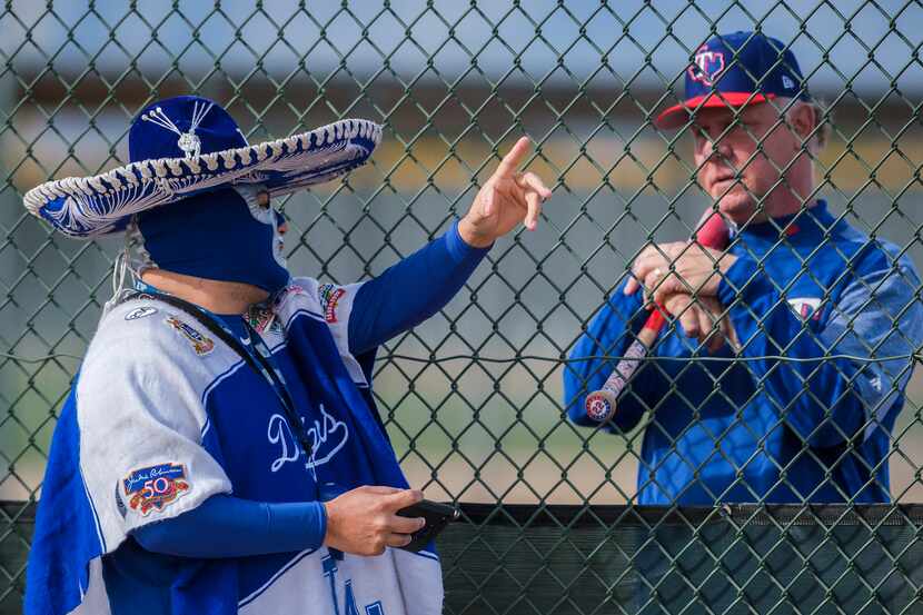 Los Angeles Dodgers fan Carlos Morales chats with Steve Buechele, Texas Rangers special...