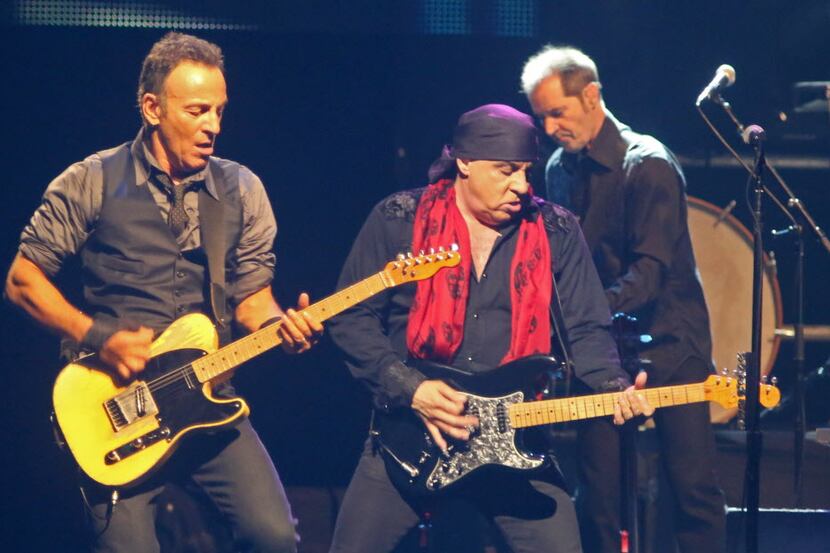 Bruce Springsteen, left, plays with band member Steven Van Zandt, right, during his live...