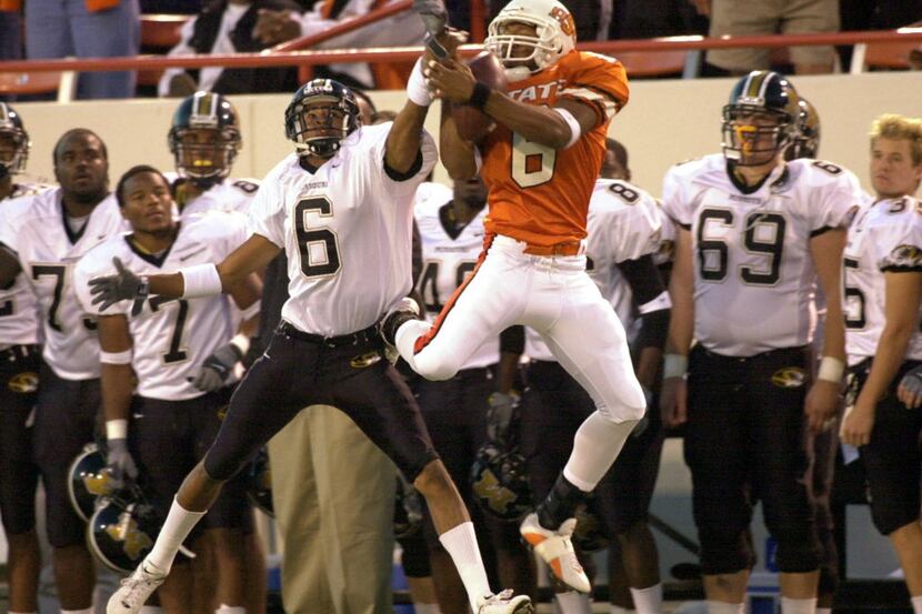 ORG XMIT: S0369773859_WIRE Oklahoma State reciever John Lewis, right, catches a pass as...