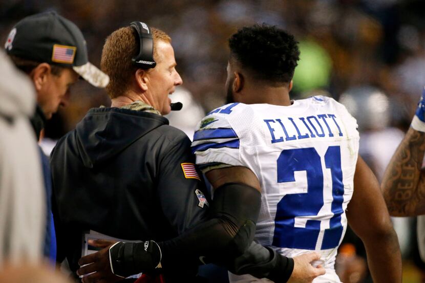Dallas Cowboys head coach Jason Garrett chats with Dallas Cowboys running back Ezekiel...