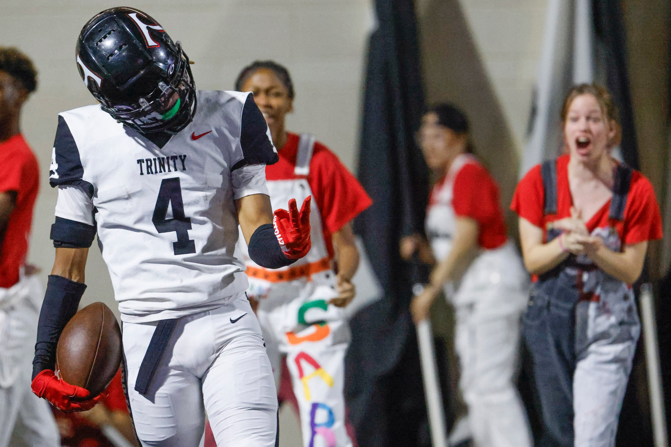 Trinity High’s Jarvis Heimuli celebrates after scoring a touchdown against Crowley High...