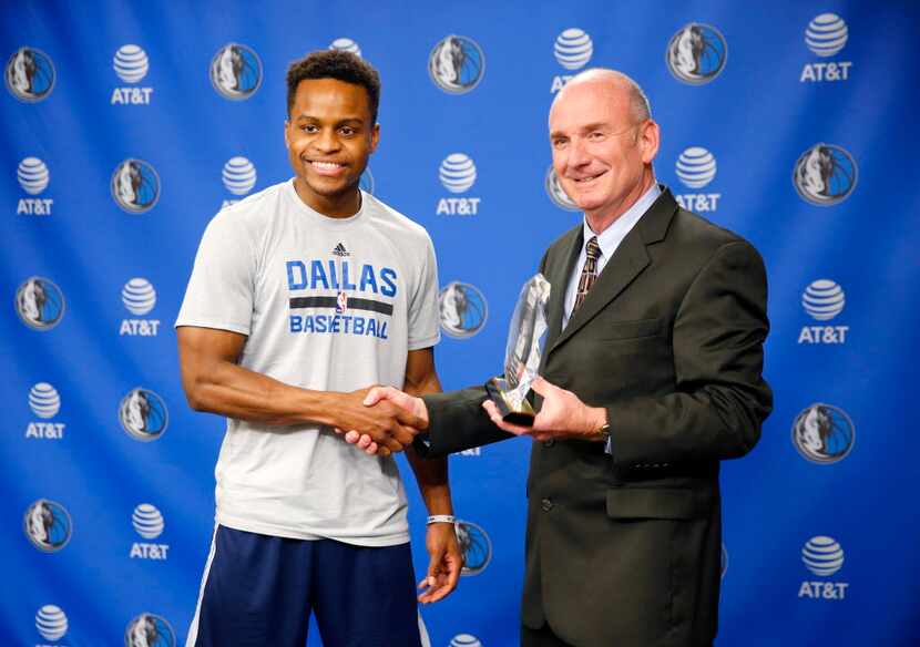 Dallas Mavericks guard Yogi Ferrell receives the NBA Rookie of the Month award from KIA...