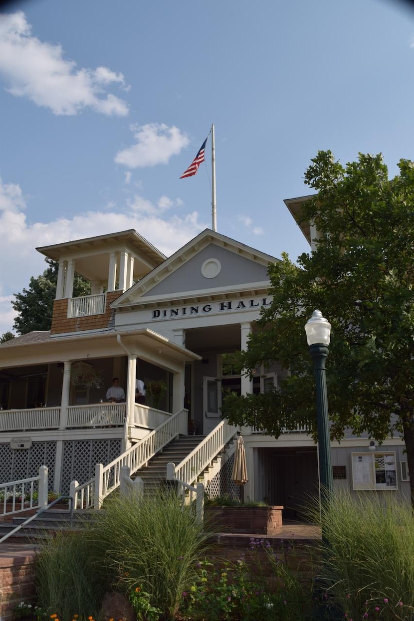 The porch of the dining   hall  offers views of the Chautauqua Green or the Flatiron Mountains.