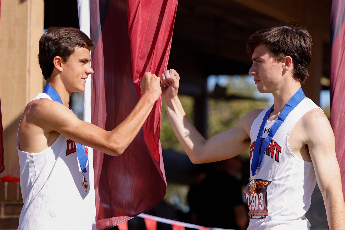 Dallas Covenant’s Logan Rice (left) fist bumps Edward Graham during an awards ceremony for...