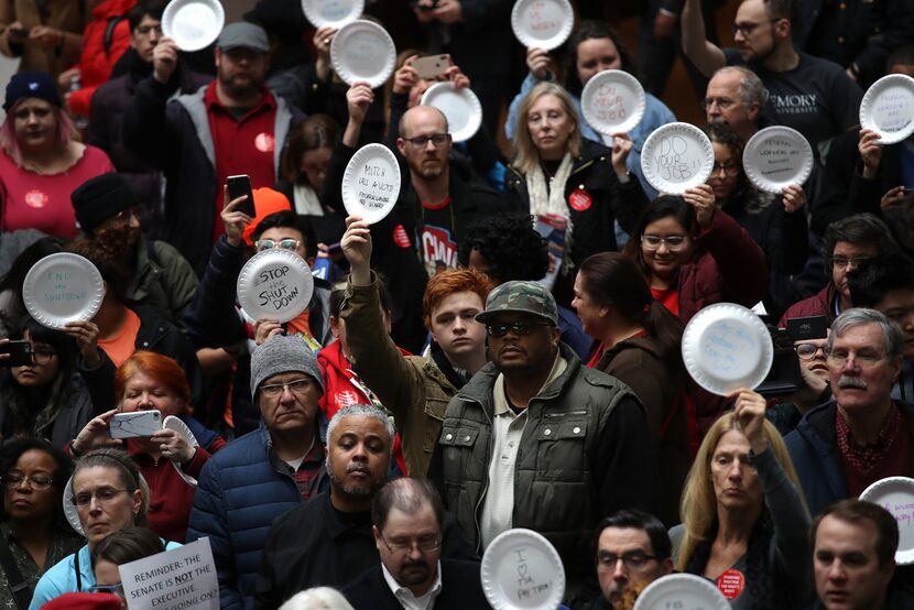 Furloughed federal workers and supporters protested the partial government shutdown inside...