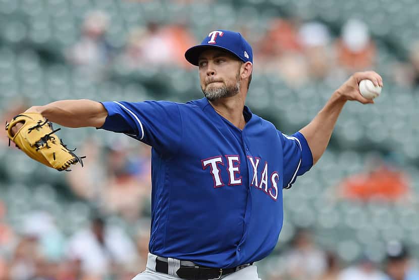Texas Rangers pitcher Mike Minor throws against the Baltimore Orioles in the first inning of...