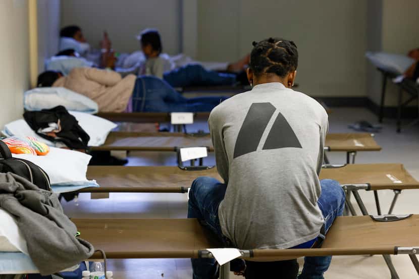 Migrants rest on cots in a room at Oak Lawn United Methodist Church in Dallas, Wednesday....