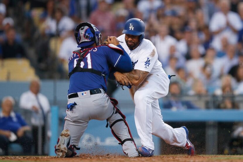 Los Angeles Dodgers' Matt Kemp, right, shoves Texas Rangers catcher Robinson Chirinos while...