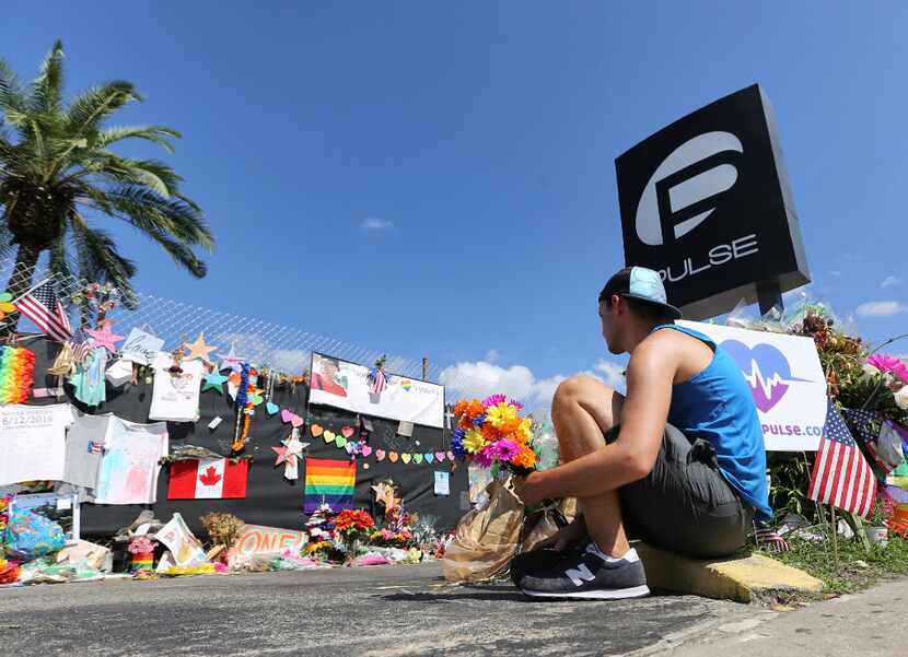 A month after the Pulse nightclub massacre, a friend of two of the victims placed flowers at...