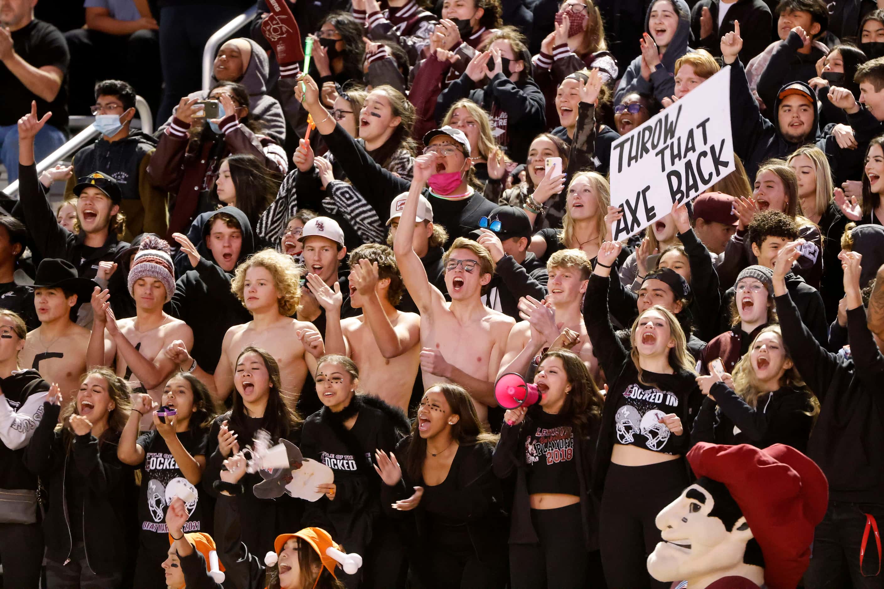 Lewisville students cheer during the cool weather as their team played Flower Mound Marcus...