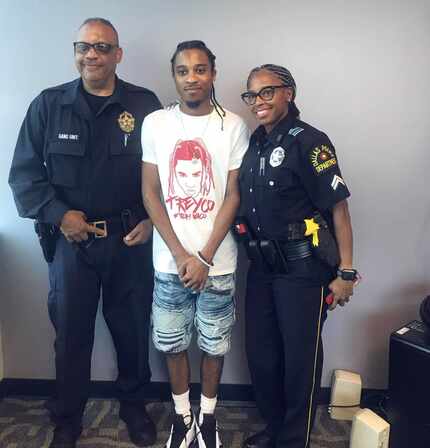 Deontrey Deshotel poses with two of the officers whose photos he posted on social media.