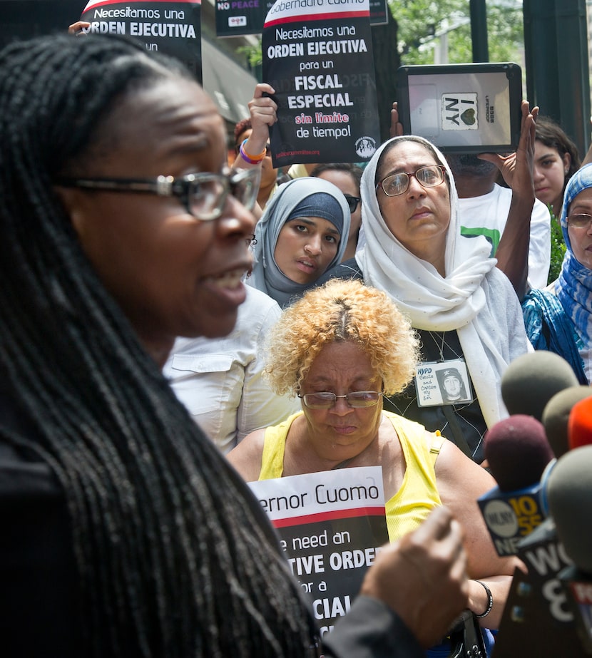 Monifa Bandele, left, human rights activist with MomsRising, speaks during a news conference...