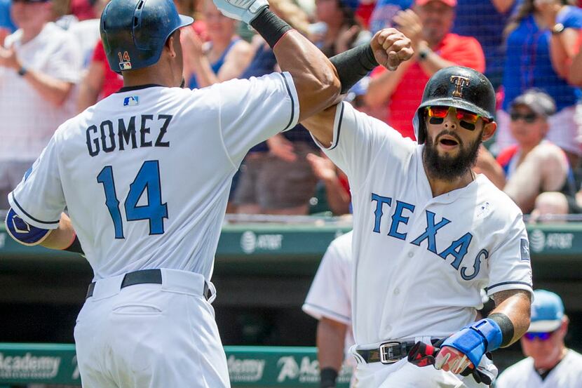 Texas Rangers center fielder Carlos Gomez celebrates with second baseman Rougned Odor...