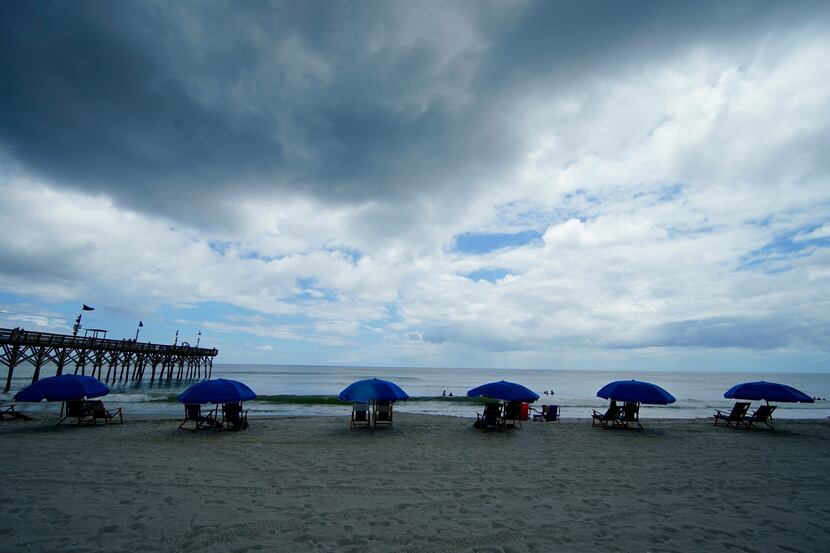 Beach umbrellas are separated on the sand Thursday, July 9, 2020, in Myrtle Beach, S.C. (AP...