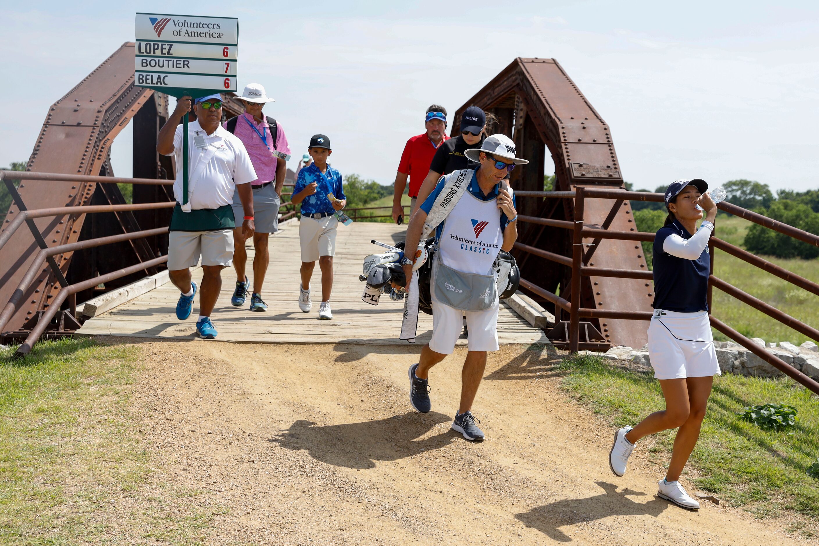 Professional golfer Celine Boutier (right) takes a drink after making par on No. 1 during...