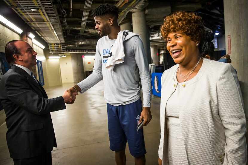 Dorcina Noel smiles as her son, Dallas Mavericks forward Nerlens Noel, chats with team COO...