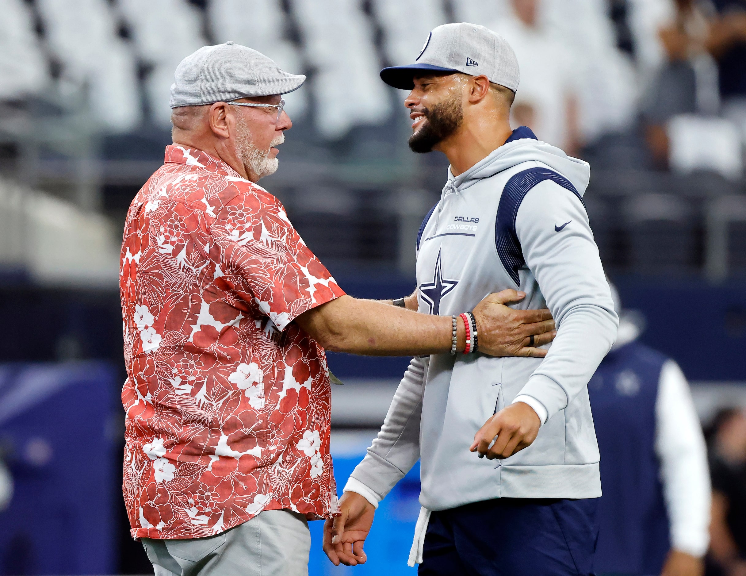 Dallas Cowboys quarterback Dak Prescott is greeted by former Tampa Bay Buccaneers head coach...